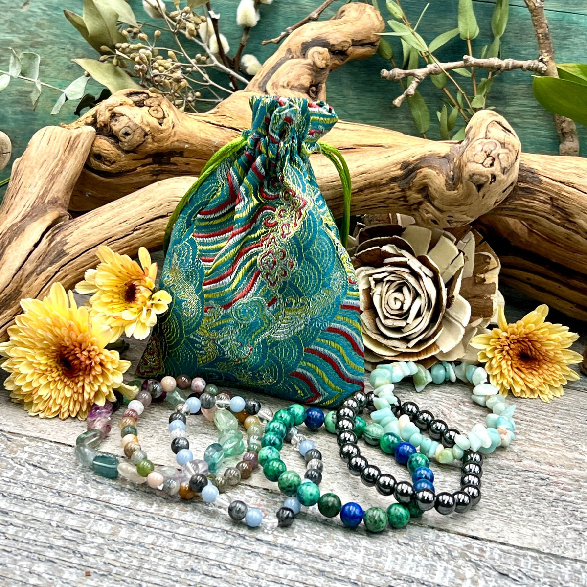 Regular Bracelet Mystery Bag with a teal brocade bag and an example six-bracelet assortment; contents vary